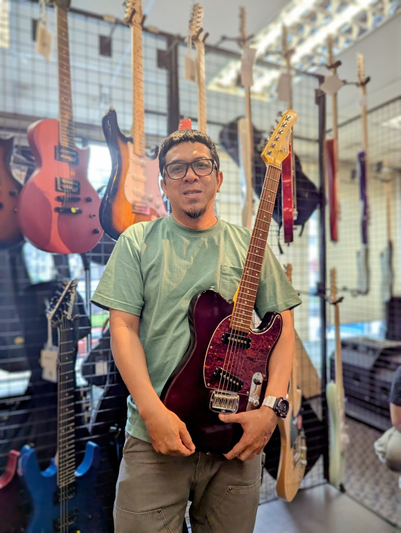 Nizam Norani from The Exact holding a freshly serviced G&L guitar in Malaysia.